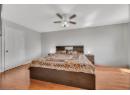 Bedroom featuring light wood-style flooring and a ceiling fan