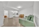 Living room featuring baseboards and light tile patterned floors