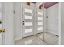Foyer with baseboards and light tile patterned floors