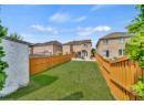 Fenced backyard with a patio area and a residential view