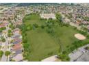 Aerial view of property's location with nearby suburban area