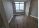 Empty room with dark wood-style floors and baseboards