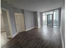 Spare room with floor to ceiling windows, dark wood-style flooring, and a textured ceiling