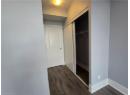 Hall with dark wood-type flooring and a textured ceiling