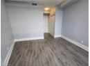 Unfurnished room with dark wood-style floors and baseboards