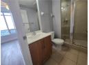 Full bathroom with vanity and a shower stall