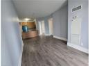 Unfurnished living room featuring a heating unit, dark wood finished floors, and a textured ceiling