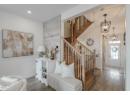 Entryway with wood finished floors, a chandelier, stairs, and recessed lighting