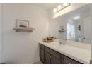 Half bathroom featuring vanity and light tile patterned floors