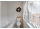 Full bathroom featuring a bath and toilet