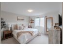 Bedroom featuring carpet floors and baseboards