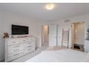Bedroom with light carpet and ensuite bathroom