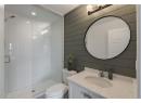 Full bathroom with a stall shower, vanity, recessed lighting, and wooden walls