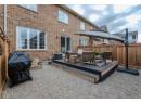 Rear view of house with brick siding, a deck, and an outdoor hangout area