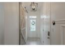 Entryway featuring a barn door, tile patterned flooring, and a chandelier