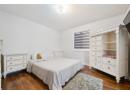 Bedroom featuring dark wood-type flooring and a textured ceiling