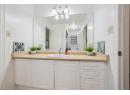 Full bathroom featuring vanity and a shower with door