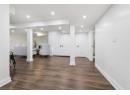 Finished below grade area featuring dark wood-style floors and recessed lighting
