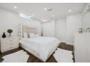 Bedroom with dark wood-style floors and recessed lighting