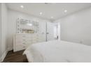 Bedroom with dark wood finished floors and recessed lighting