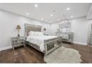 Bedroom with dark wood finished floors and recessed lighting