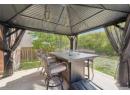Fenced backyard featuring a patio area and a gazebo