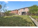 Back of property with a gazebo, a fenced backyard, a patio, and brick siding