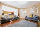 Living area with dark wood-style floors and baseboards