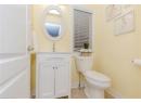 Half bath with vanity and light tile patterned flooring