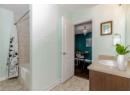 Bathroom with shower / tub combo, vanity, light tile patterned floors, and a chandelier