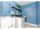 Washroom featuring light tile patterned floors and separate washer and dryer
