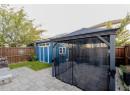 Fenced backyard with a gazebo, a patio area, and a storage unit