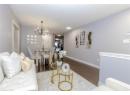 Living area featuring wood finished floors, a chandelier, and recessed lighting