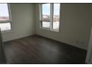 Unfurnished room featuring dark wood-type flooring and plenty of natural light