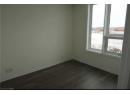 Empty room with baseboards and dark wood-type flooring