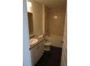 Bathroom featuring dark tile patterned flooring, vanity, and shower / bathtub combination