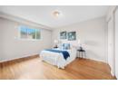 Bedroom with light wood finished floors and baseboards