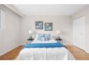 Bedroom featuring wood finished floors and baseboards