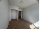 Spare room with wood finished floors and a textured ceiling