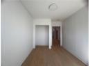 Hallway featuring light wood finished floors and baseboards