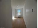 Hall with light wood-style floors and radiator