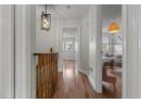 Corridor with dark wood-style floors and baseboards