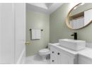 Finished below grade area with light wood-style floors and baseboards