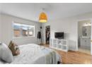 Bedroom with wood finished floors and baseboards