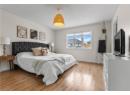 Bedroom with light wood-style floors and a textured ceiling