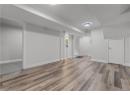 Finished basement featuring dark wood finished floors and baseboards