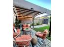 Fenced backyard featuring a storage shed, a patio area, an outdoor living space with a fire pit, a pergola, and grilling area