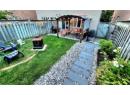 Fenced backyard featuring a storage shed, a patio area, an outdoor living space with a fire pit, a pergola, and grilling area
