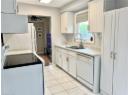 Kitchen featuring white appliances, ceiling fan, white cabinetry, light countertops, and light tile patterned floors