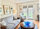Living area with light wood-style floors and a textured ceiling